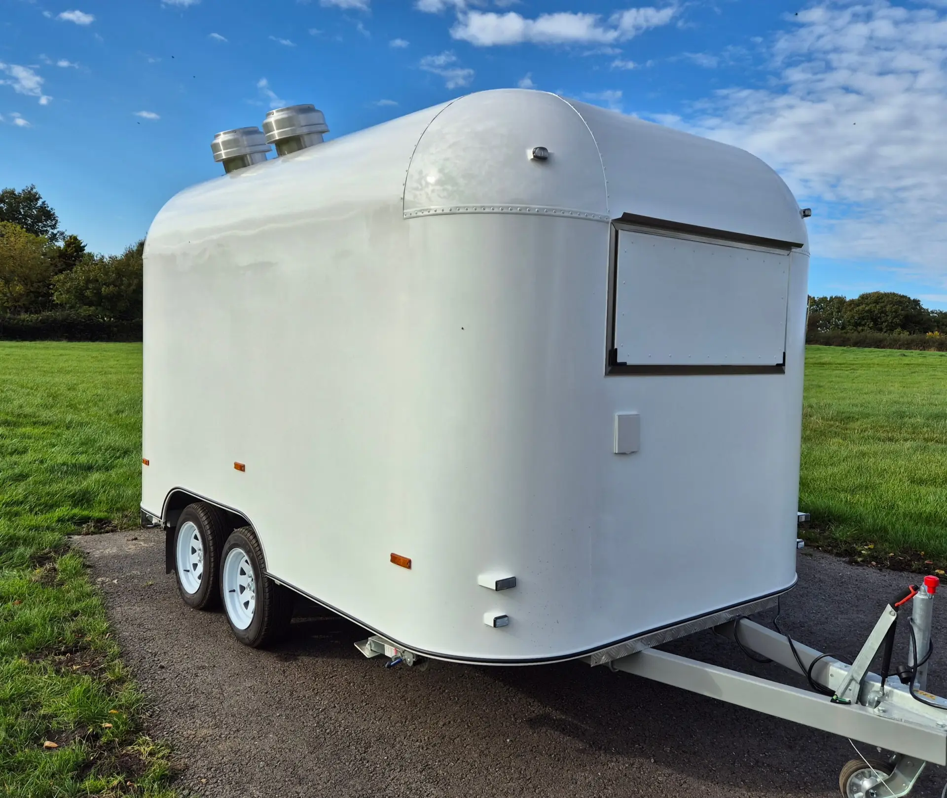 White street food trailer exterior with serving hatch open, shown from rear quarter angle